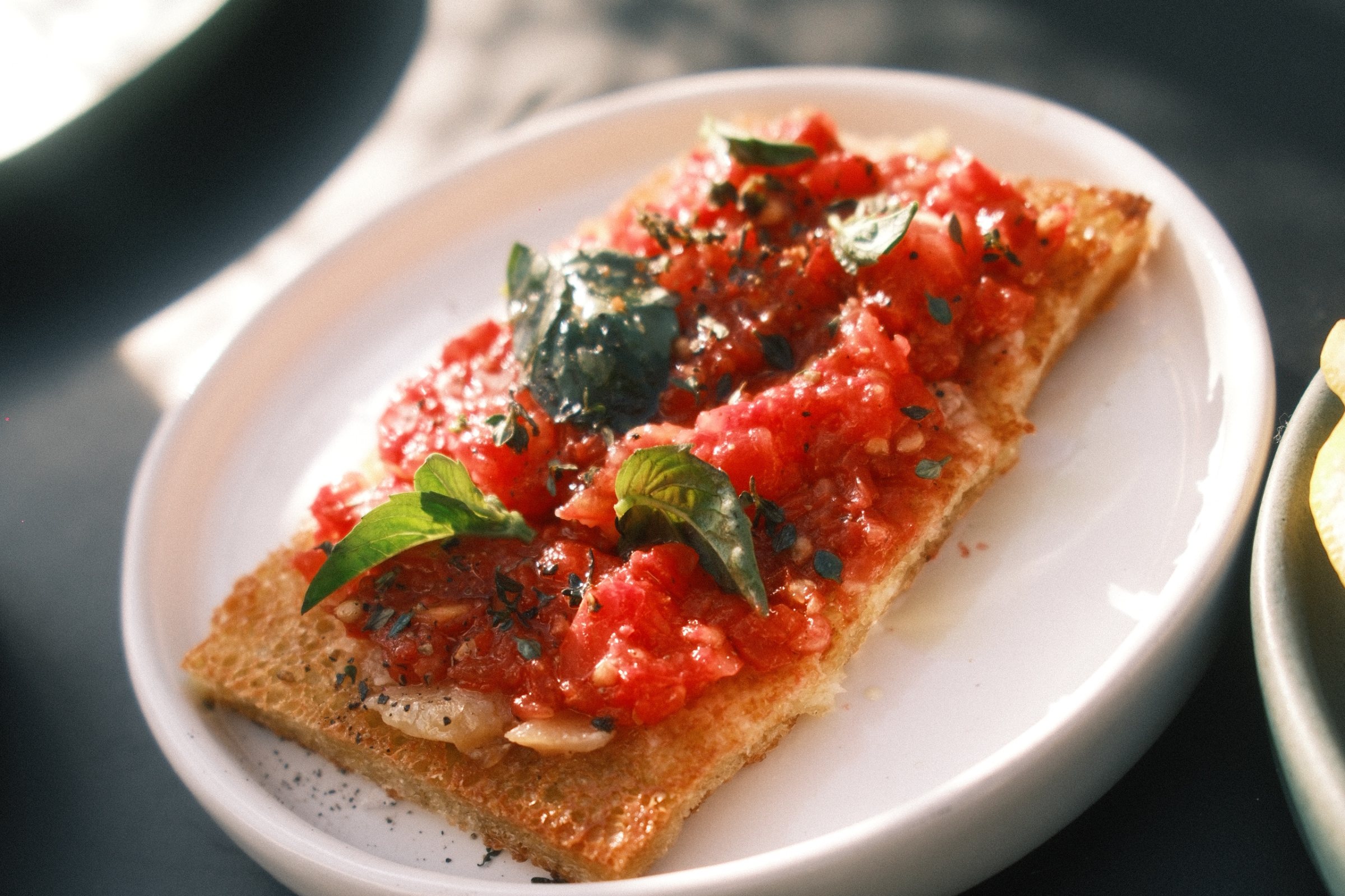 Tomato bruschetta with basil and oregano on grilled bread, served at aperitivo at Market in Venice Beach