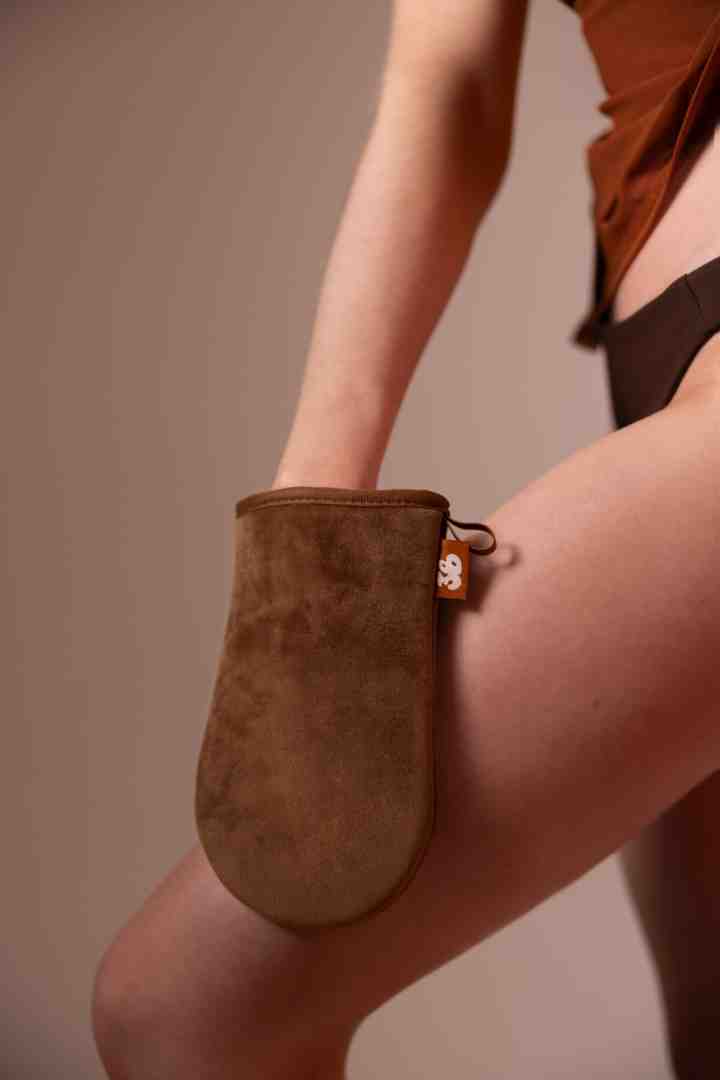 Application process: spritzing water on a mitt. - hydrating self tanner Application process: spritzing water on a mitt. - hydrating self tanner