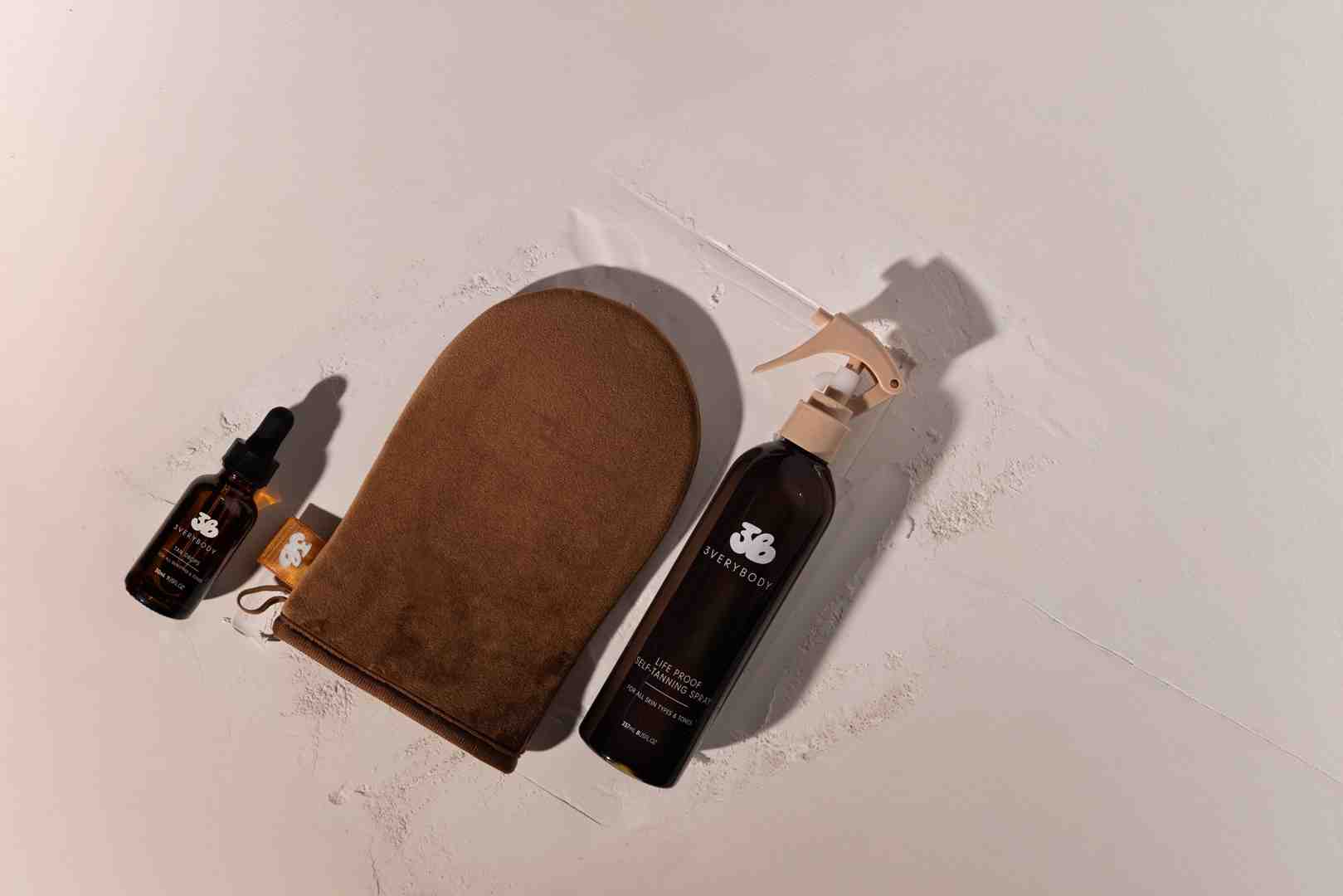 3VERYBODY Kit with Tinted Tanning Water, Tanning Drops, and Tanning Mitt on a clean, modern background - fake tan lasts 3 weeks