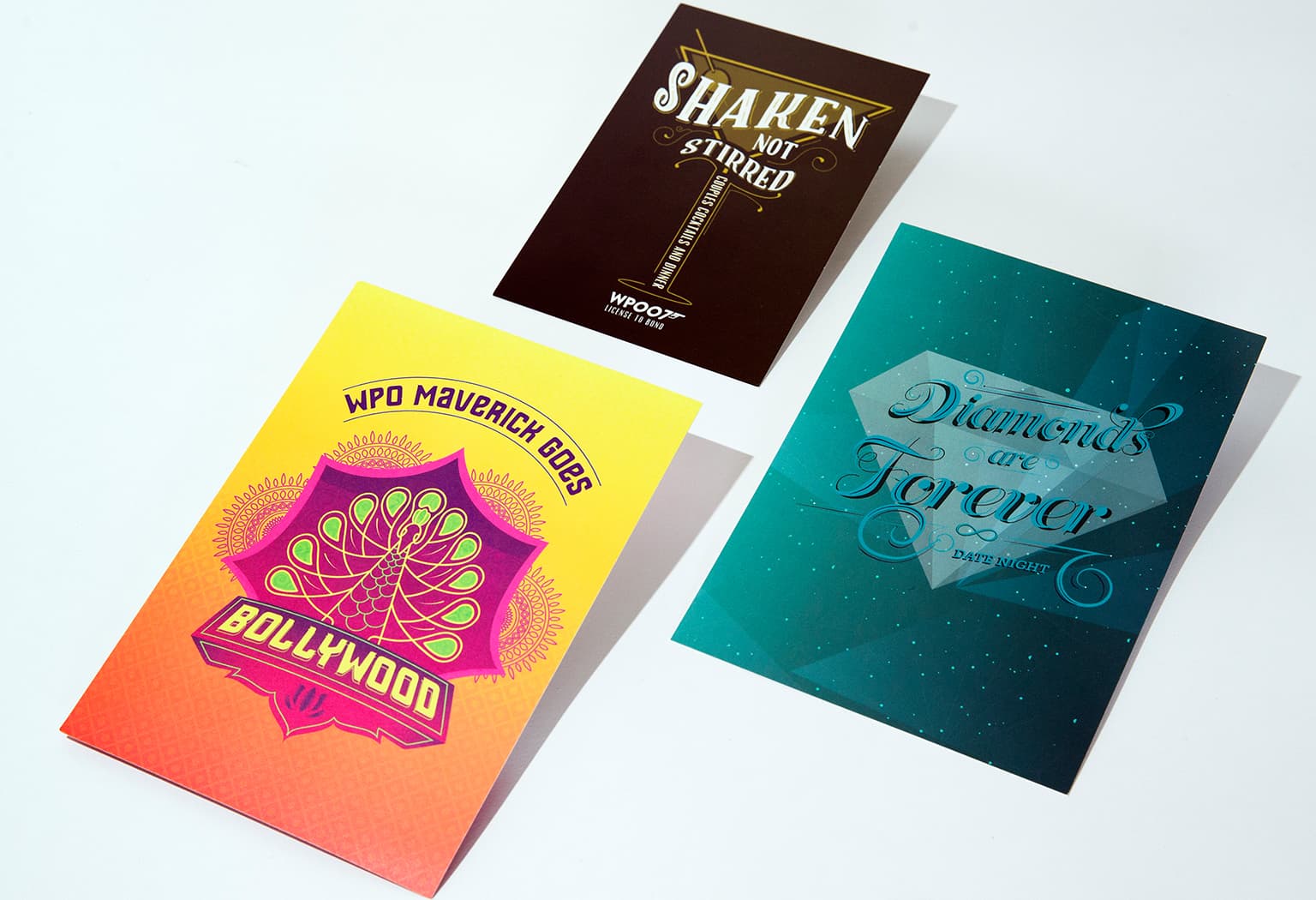 Three unique invitation designs for YPO Gold Maverick events, uniquely designed with colorful artwork depicting the themes of James Bond movies