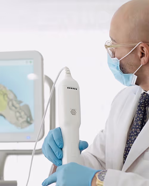 Dentist using advanced tech for Invisalign consultation, digital scan of patient's teeth.