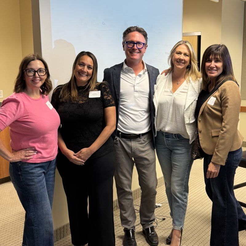 Shawn Mills, CEO of Pisteyo posing with the speaking panel of SIM Women Colorado after speaking about the future of productivity with AI