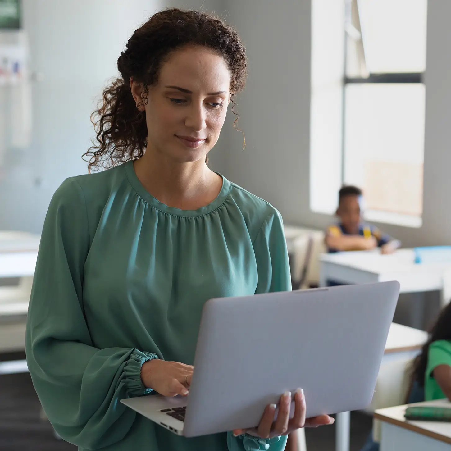 Healthcare professional using Risk Management Software smiling at camera