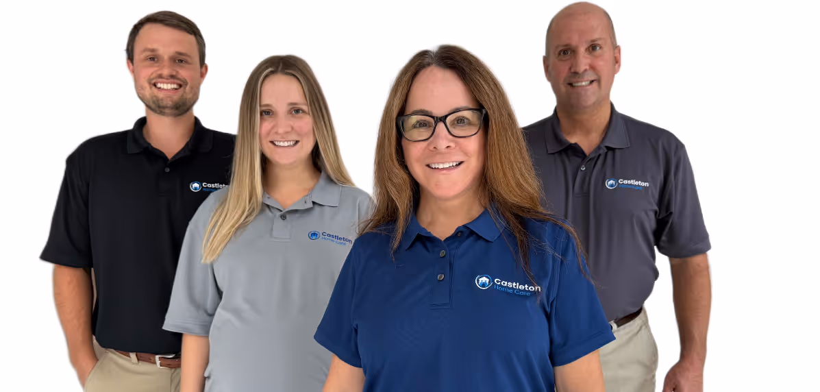 Picture of two ladies and two men smiling while wearing Castleton Home Care polos. 