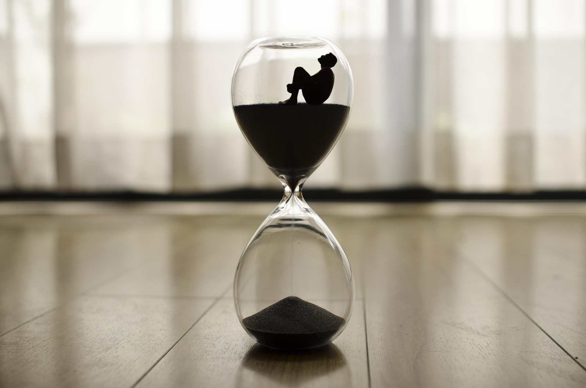 A person sitting inside an hour glass