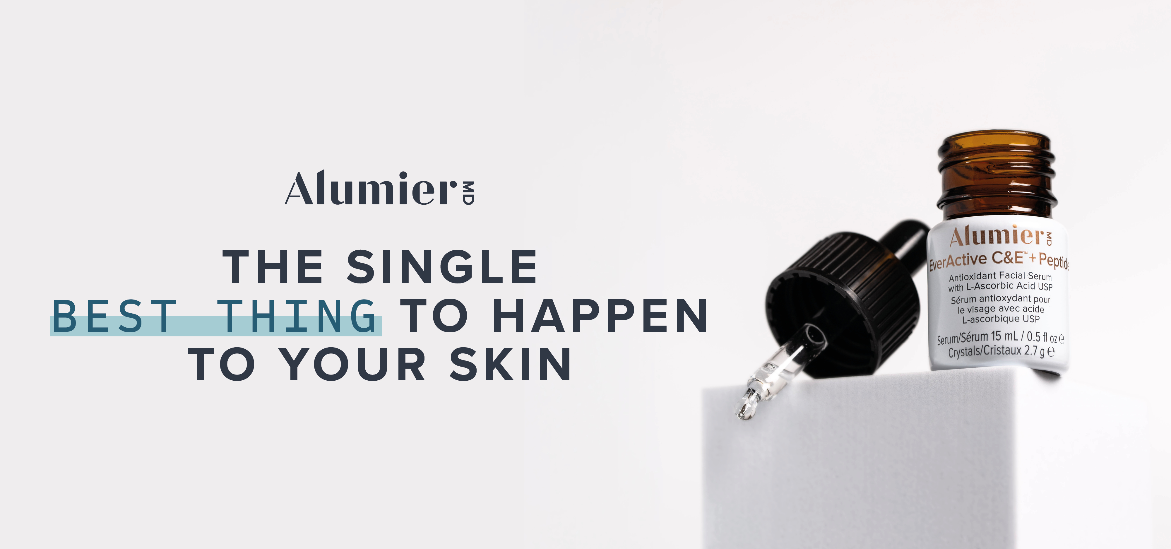 Bottle of AlumierMD EverActive C&E Peptide antioxidant serum with dropper on white block.