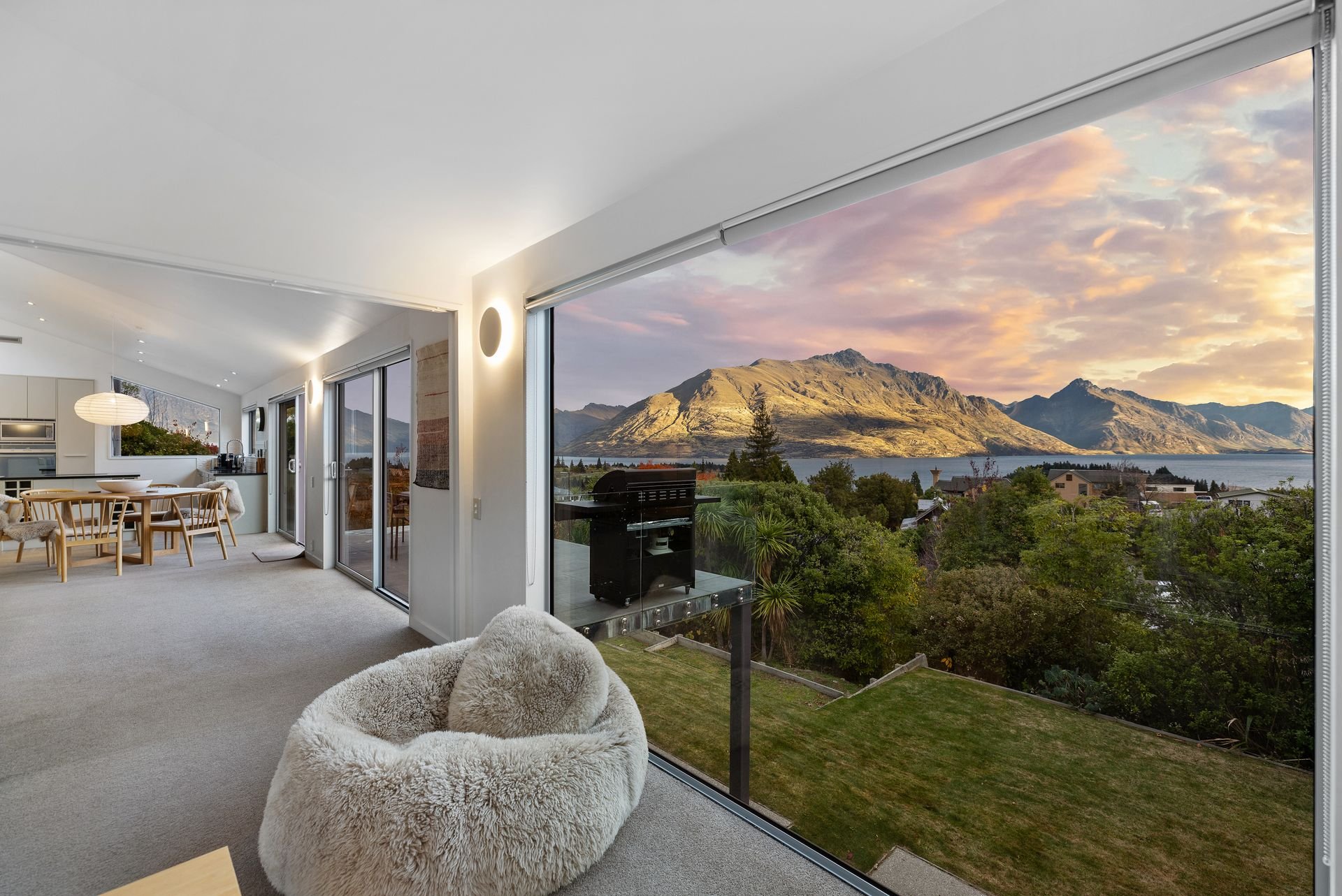 Open-plan living area with sunset views over Lake Whakatipu at Hillside Haven Queenstown