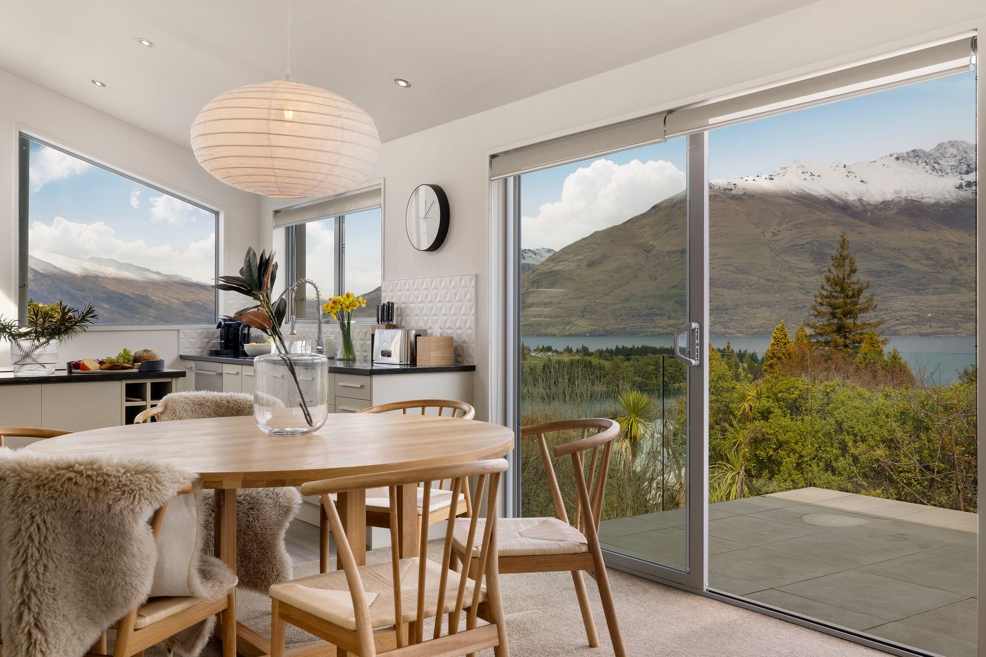 Dining area with lake and snow-capped mountain views at Hillside Haven Queenstown
