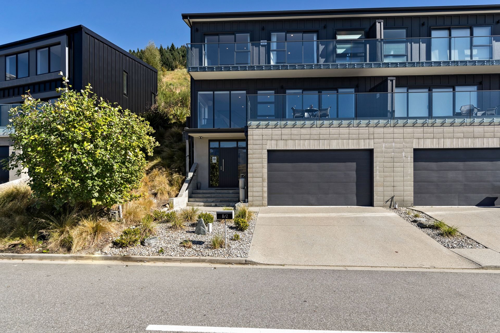 Exterior with double garage for secure bike storage at Cecil Peak House, Queenstown