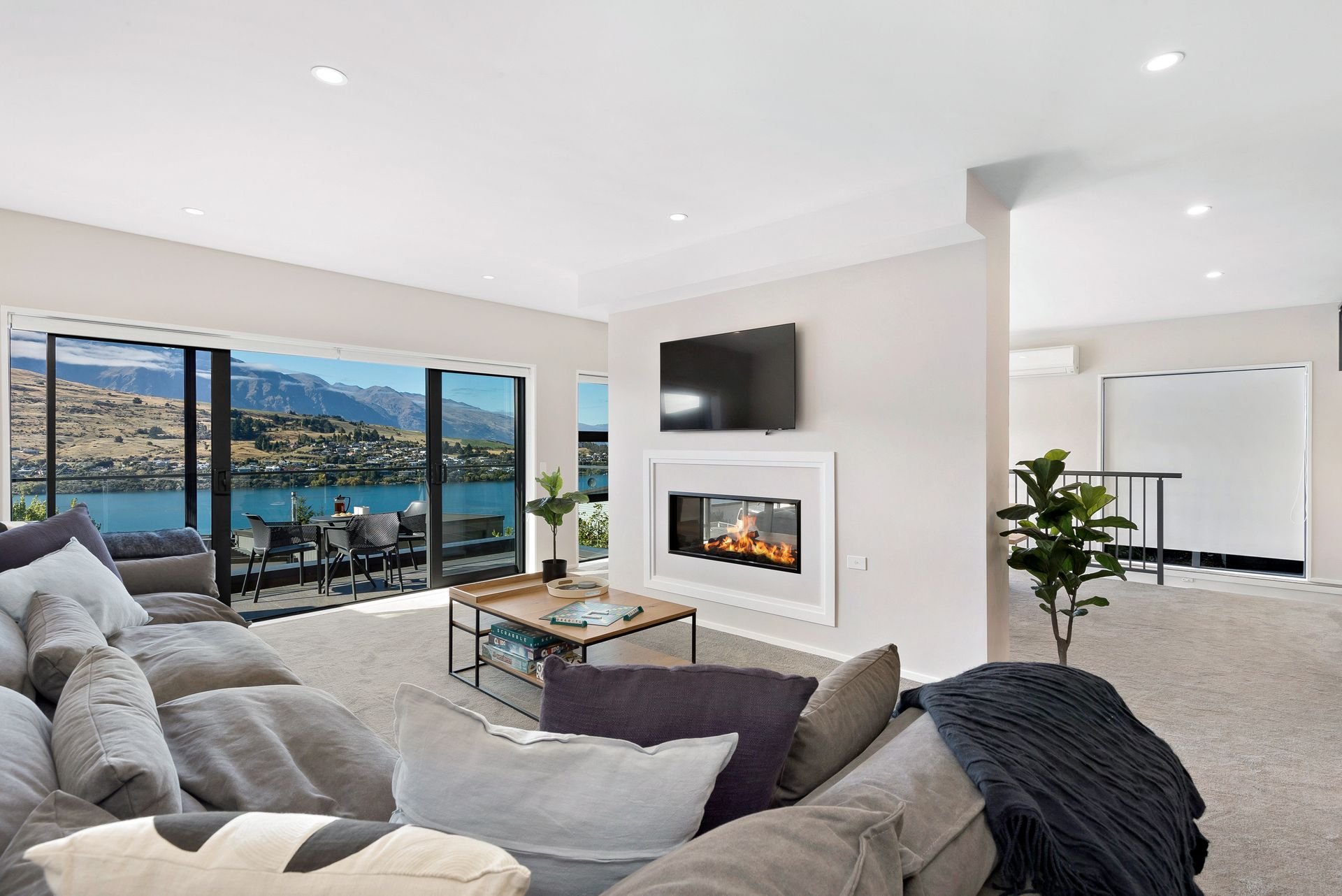 Open-plan living room with lake views at Cecil Peak House, Queenstown