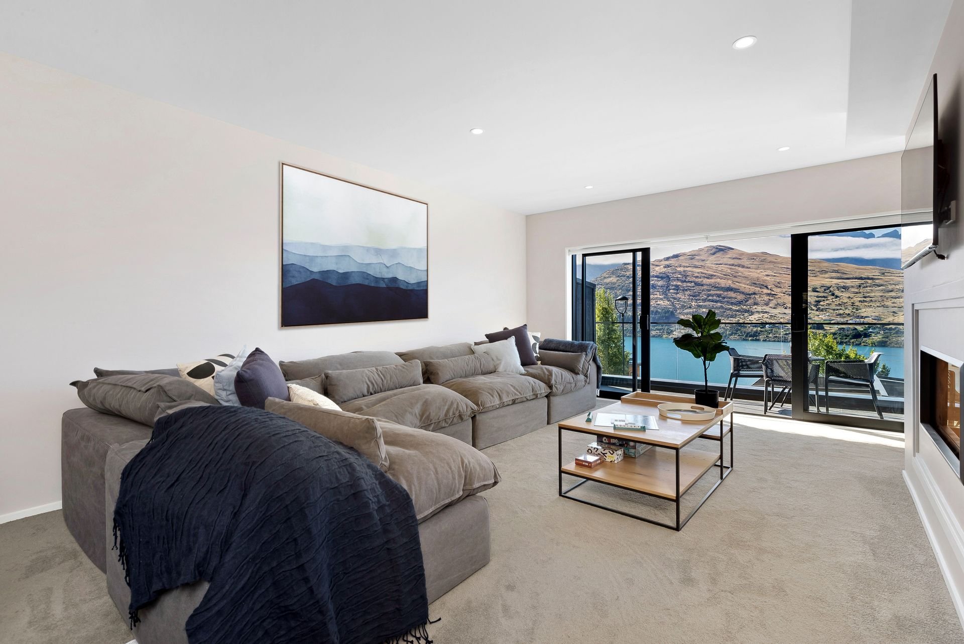 Living room sofa with lake views at Cecil Peak House, Queenstown