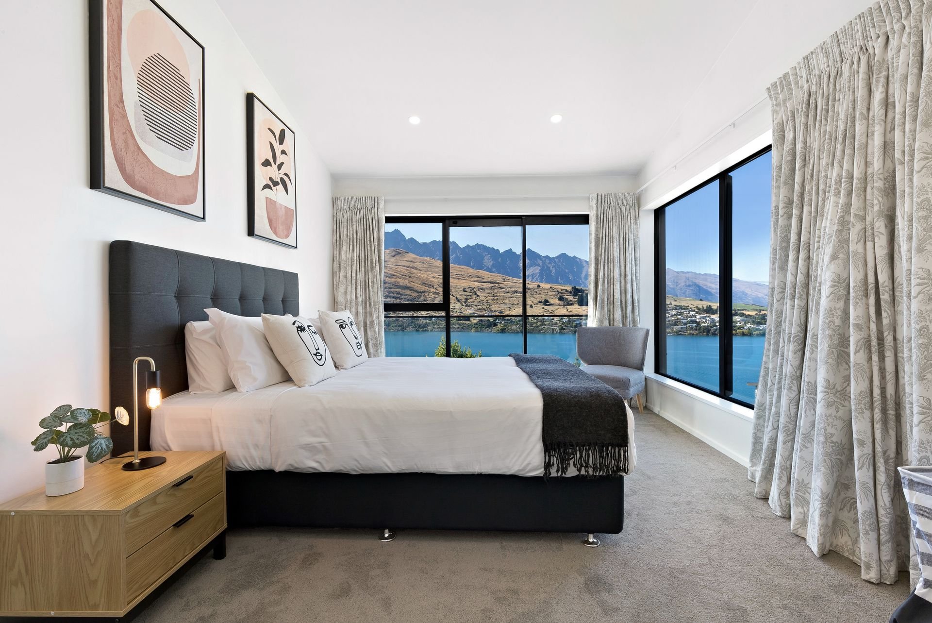 Bedroom with corner windows overlooking the lake at Cecil Peak House, Queenstown