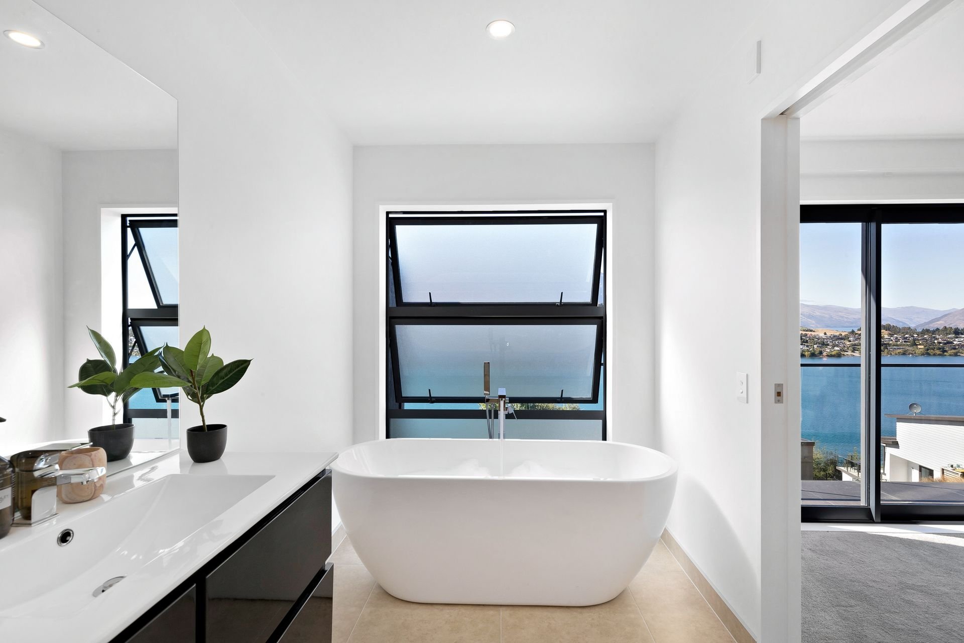 Bathroom with freestanding bath and lake view at Cecil Peak House, Queenstown