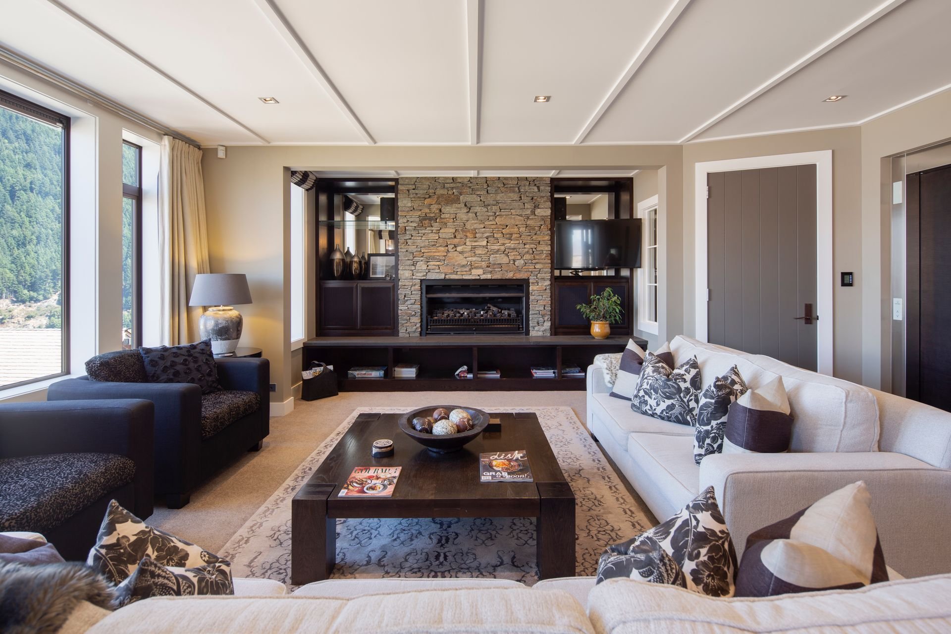 Lounge with schist stone fireplace at Karamata, Queenstown