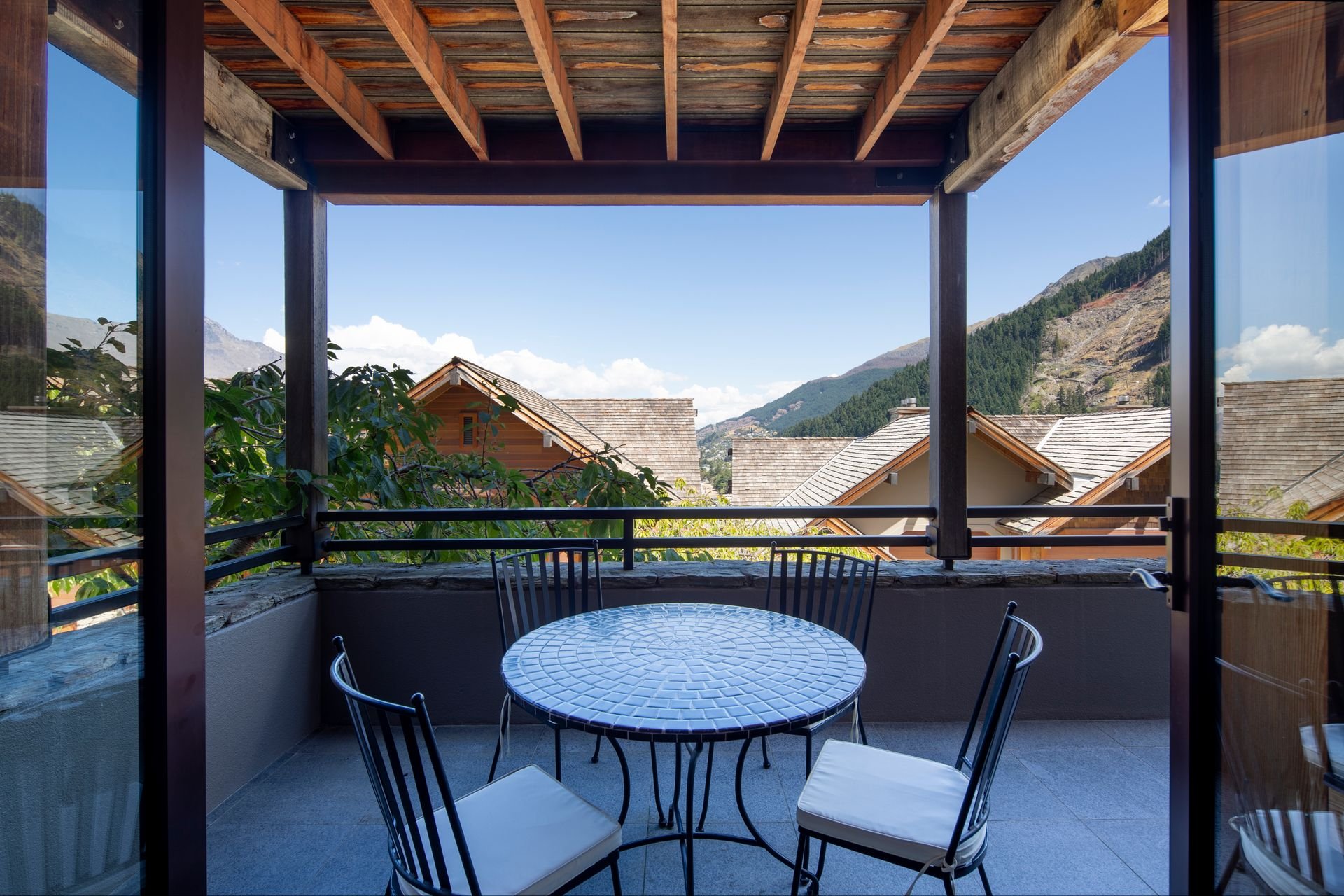 Covered terrace with outdoor table and lake view at Karamata, Queenstown