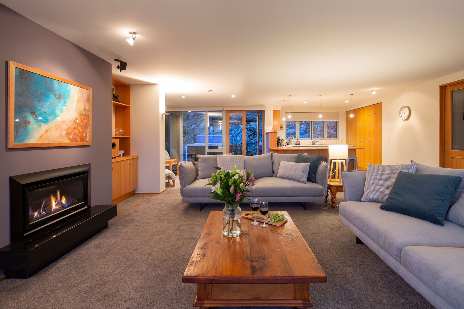 Living room with fireplace at Baraka Lake Views, Queenstown