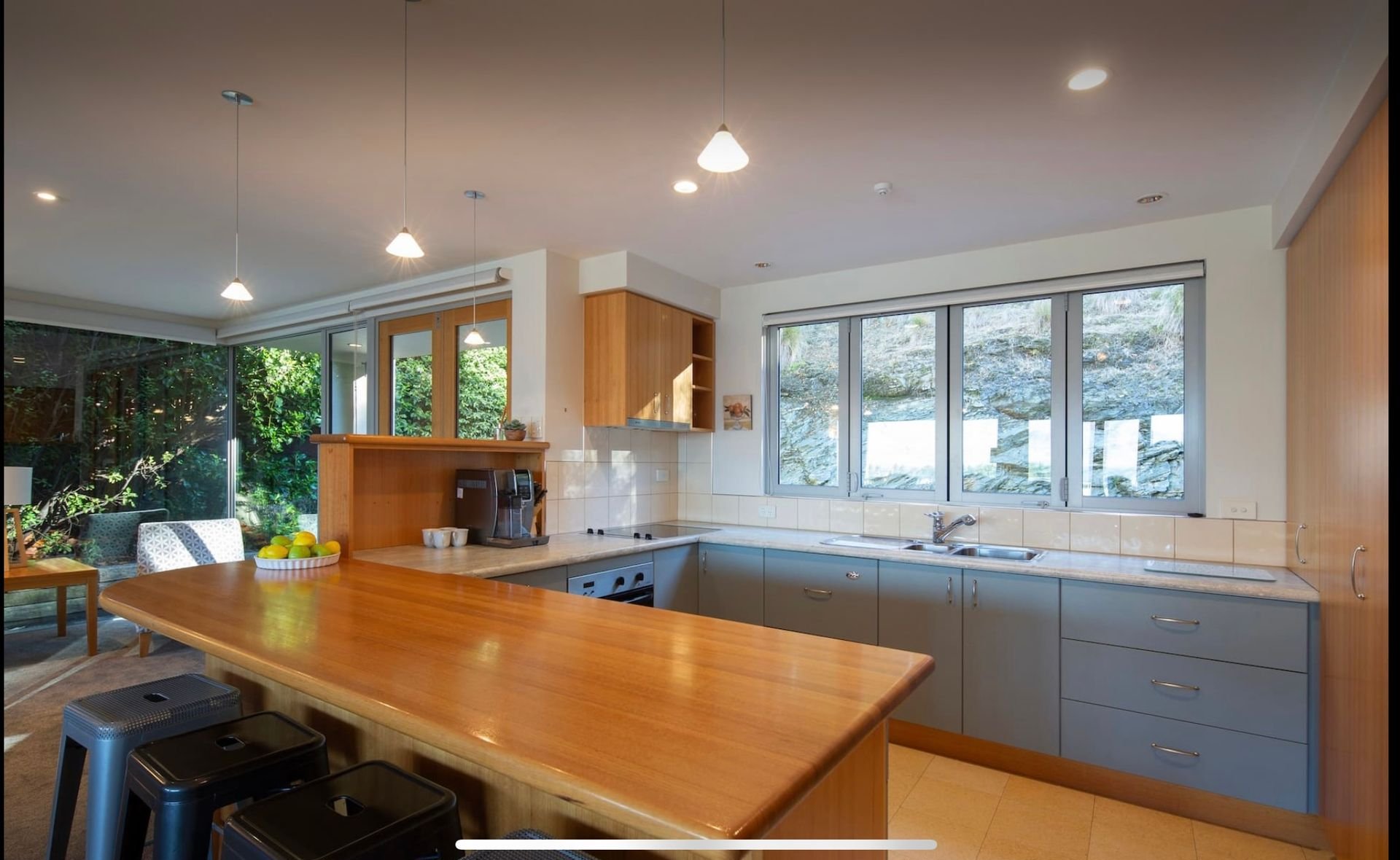 Kitchen with timber breakfast bar at Baraka Lake Views, Queenstown