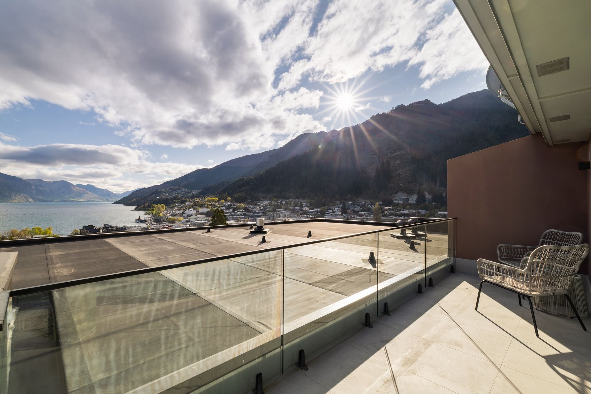 Balcony with glass balustrade and lake views at Sunset Views, Queenstown