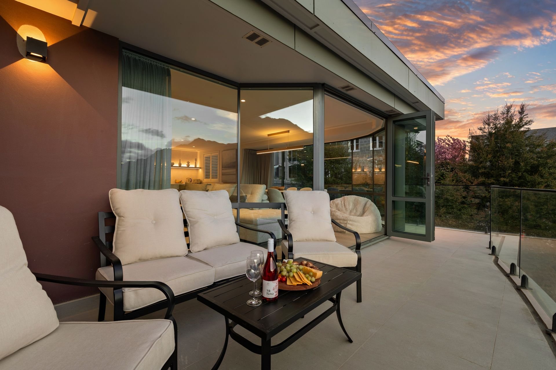 Balcony with outdoor sofa at sunset at Sunset Views, Queenstown