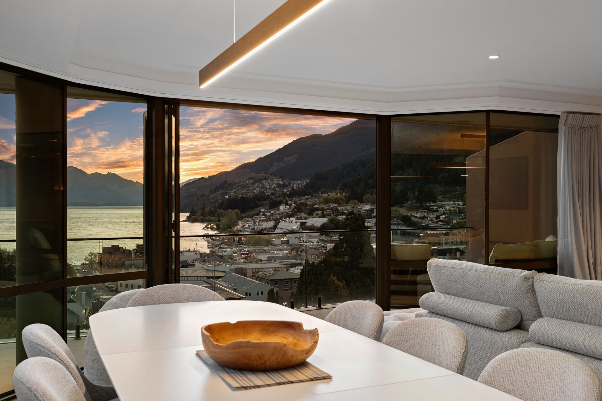 Dining area with lake views at dusk at Sunset Views, Queenstown