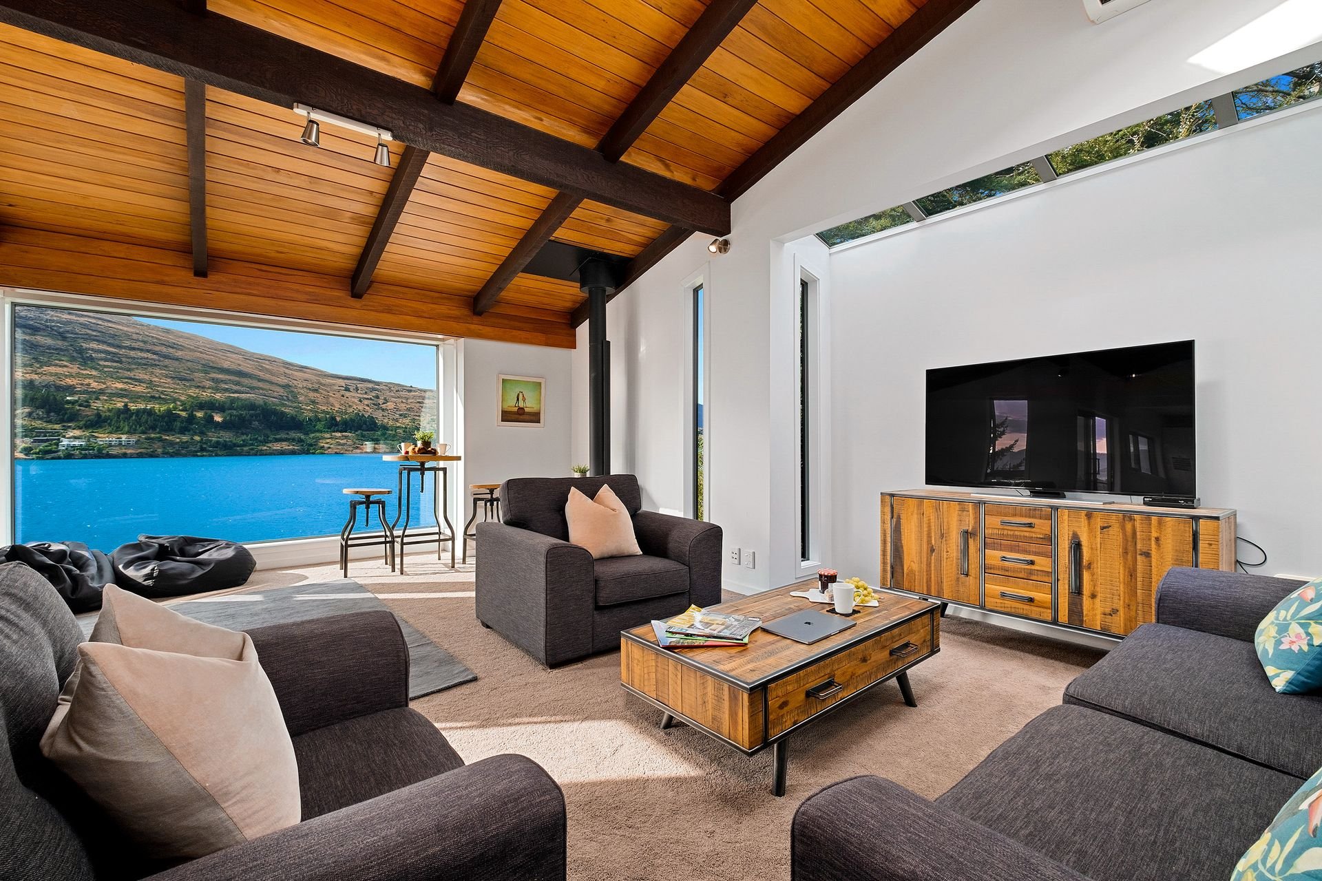 Lounge with timber ceiling and lake view at Queenstown Lakefront Dream, Queenstown