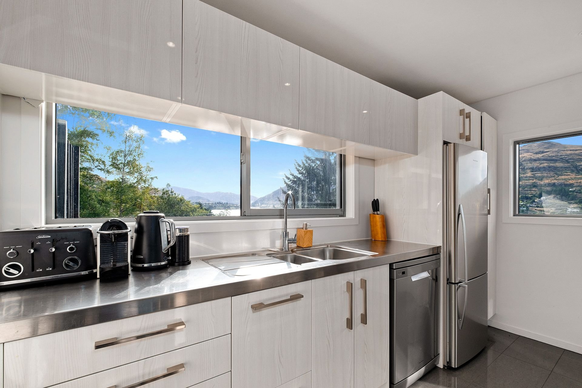 Kitchen with a window over the lake at Queenstown Lakefront Dream, Queenstown