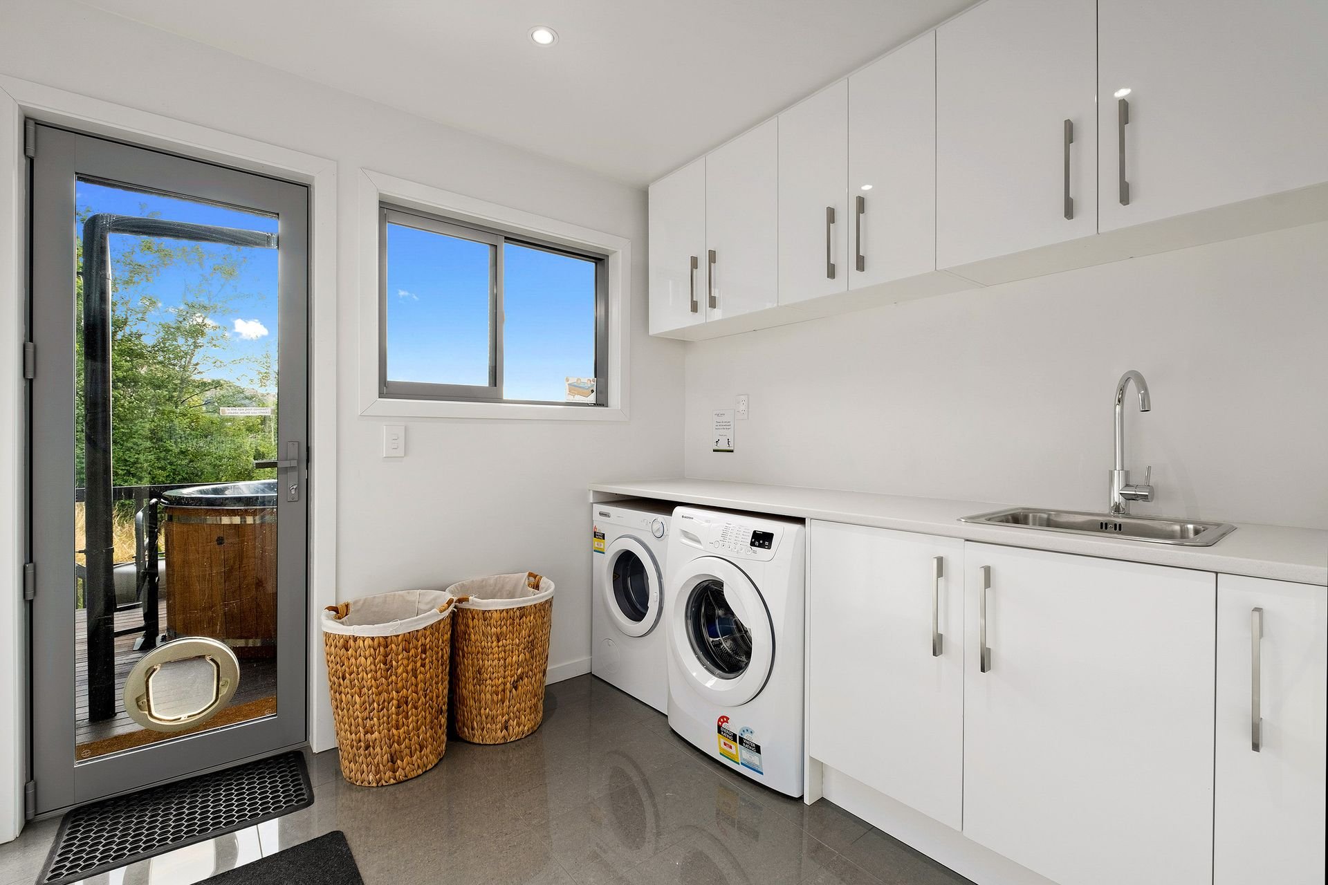 Laundry with washer and dryer at Queenstown Lakefront Dream, Queenstown