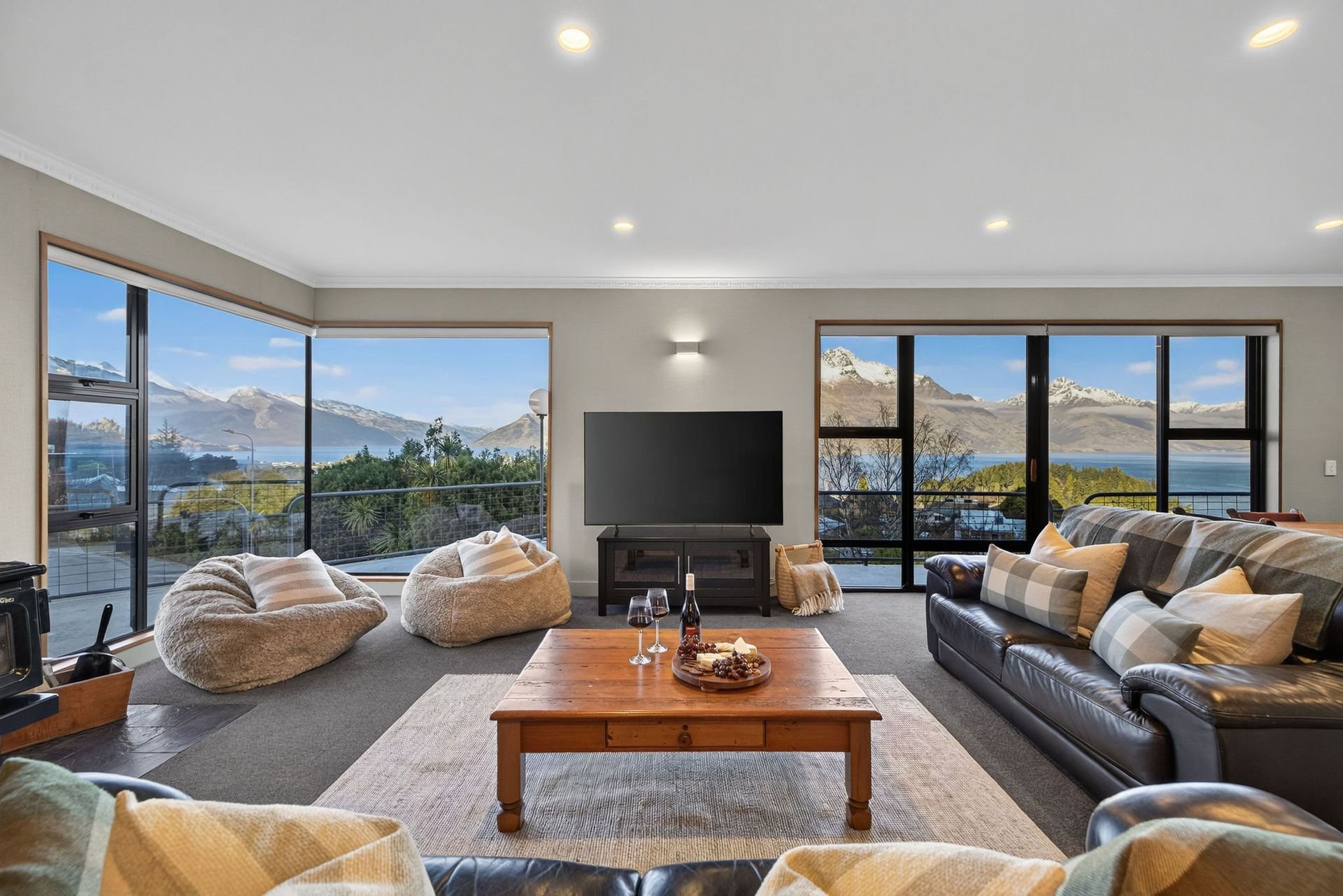 Living room with lake and mountain views at Alpine Haven, Queenstown