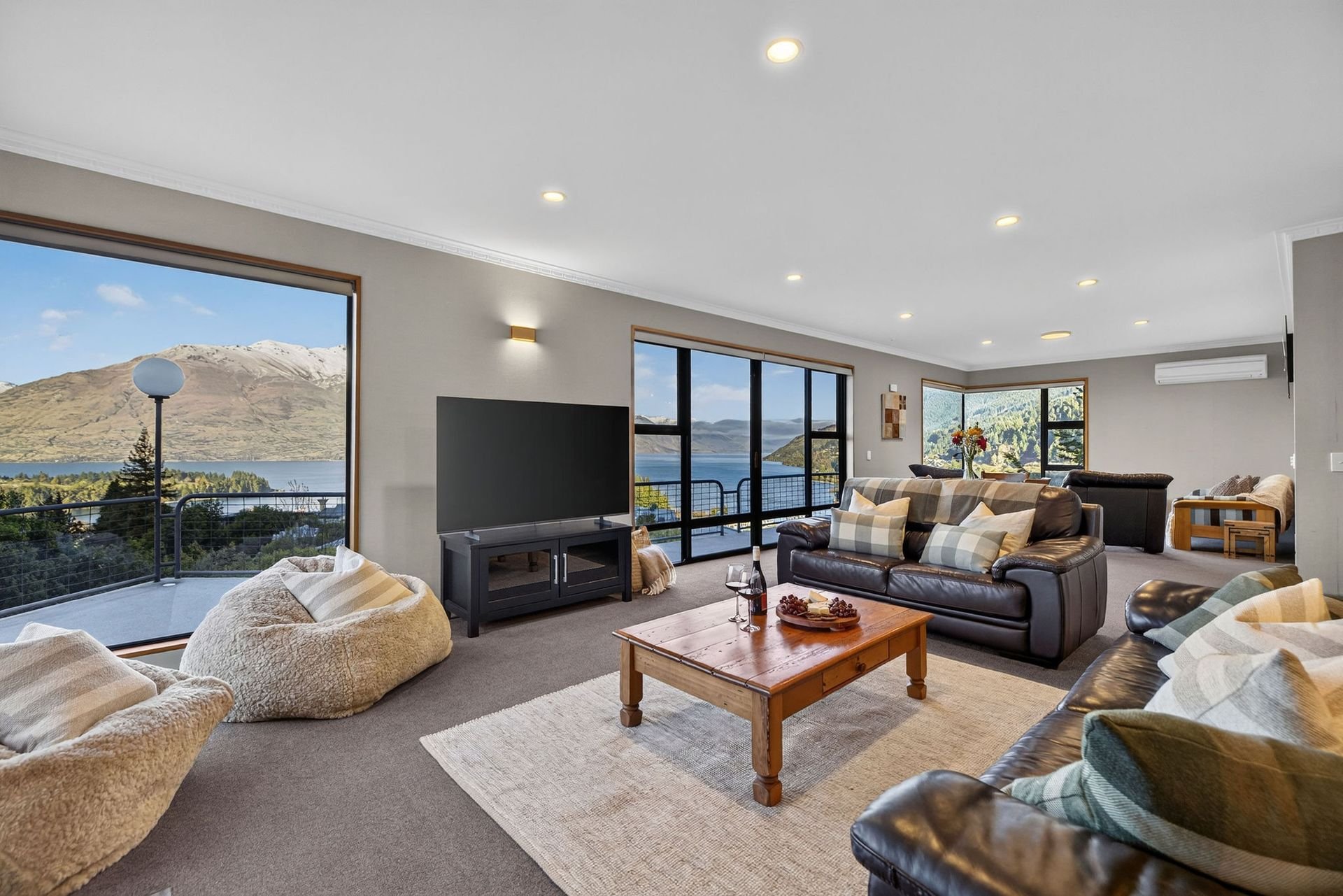 Living area with sofas and TV at Alpine Haven, Queenstown
