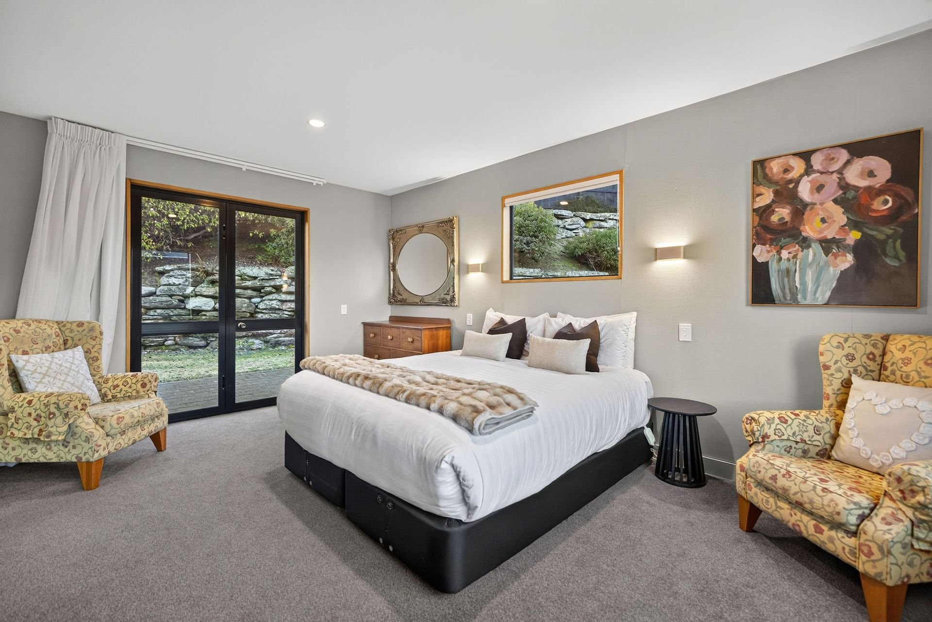 Main bedroom with armchairs at Alpine Haven, Queenstown