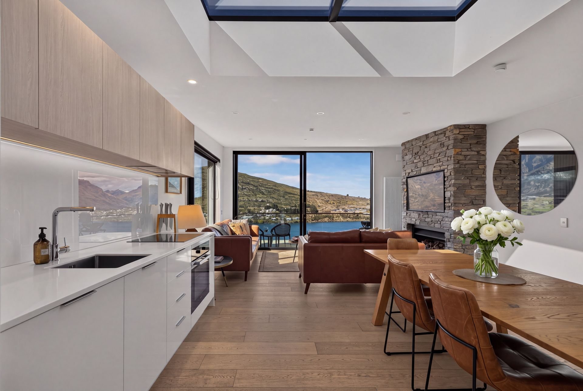 Kitchen bench and dining table with lake views at Woods Villa Tui, Queenstown
