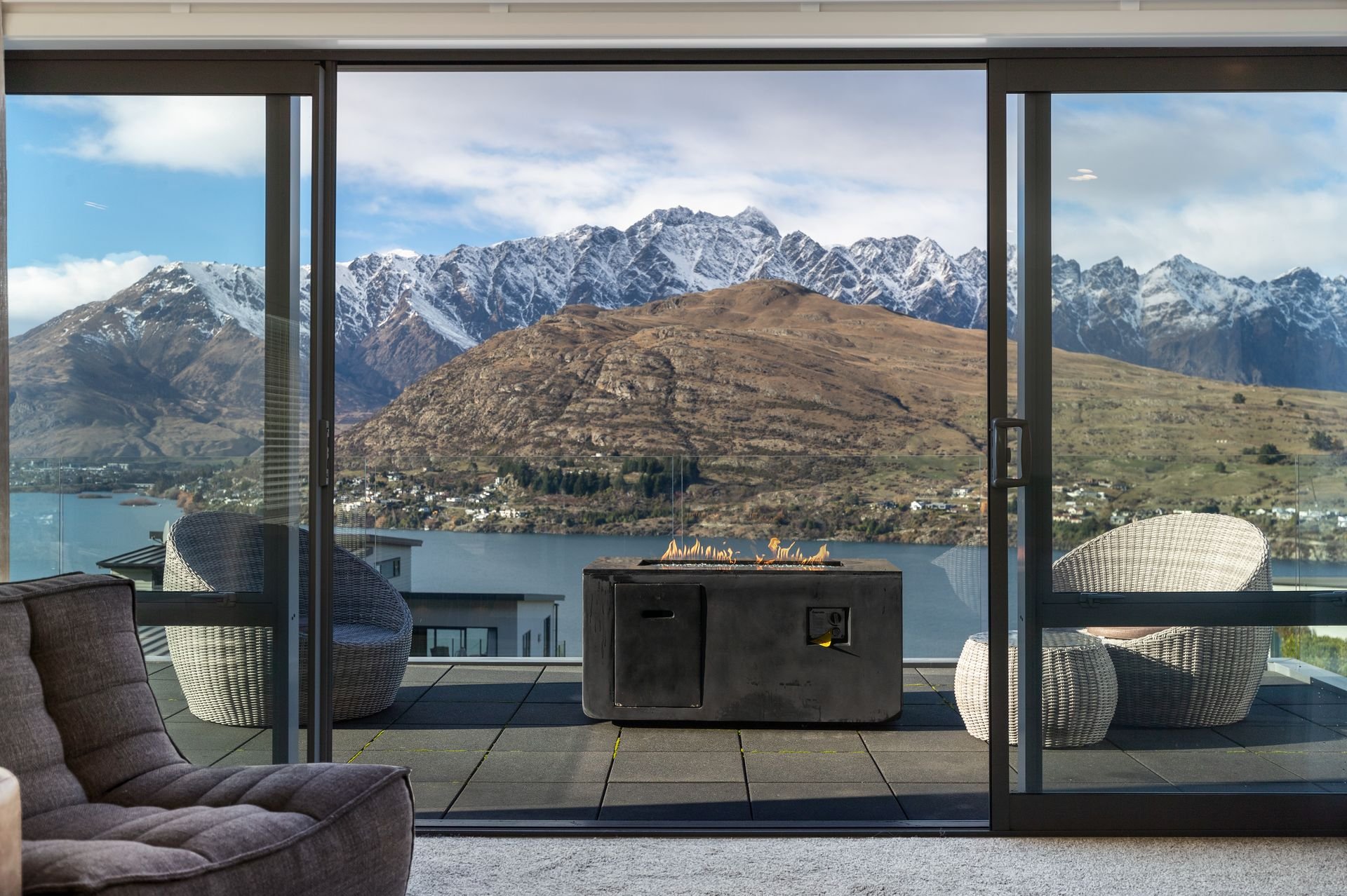 Lounge opening to the balcony with views of the Remarkables at Highview Haven, Queenstown