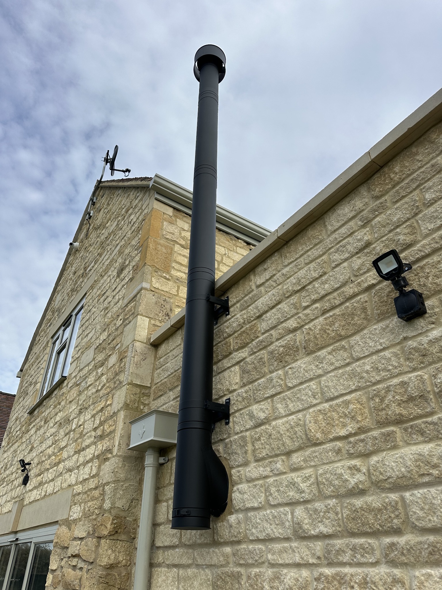 Our black insulated flue installation on a stone property