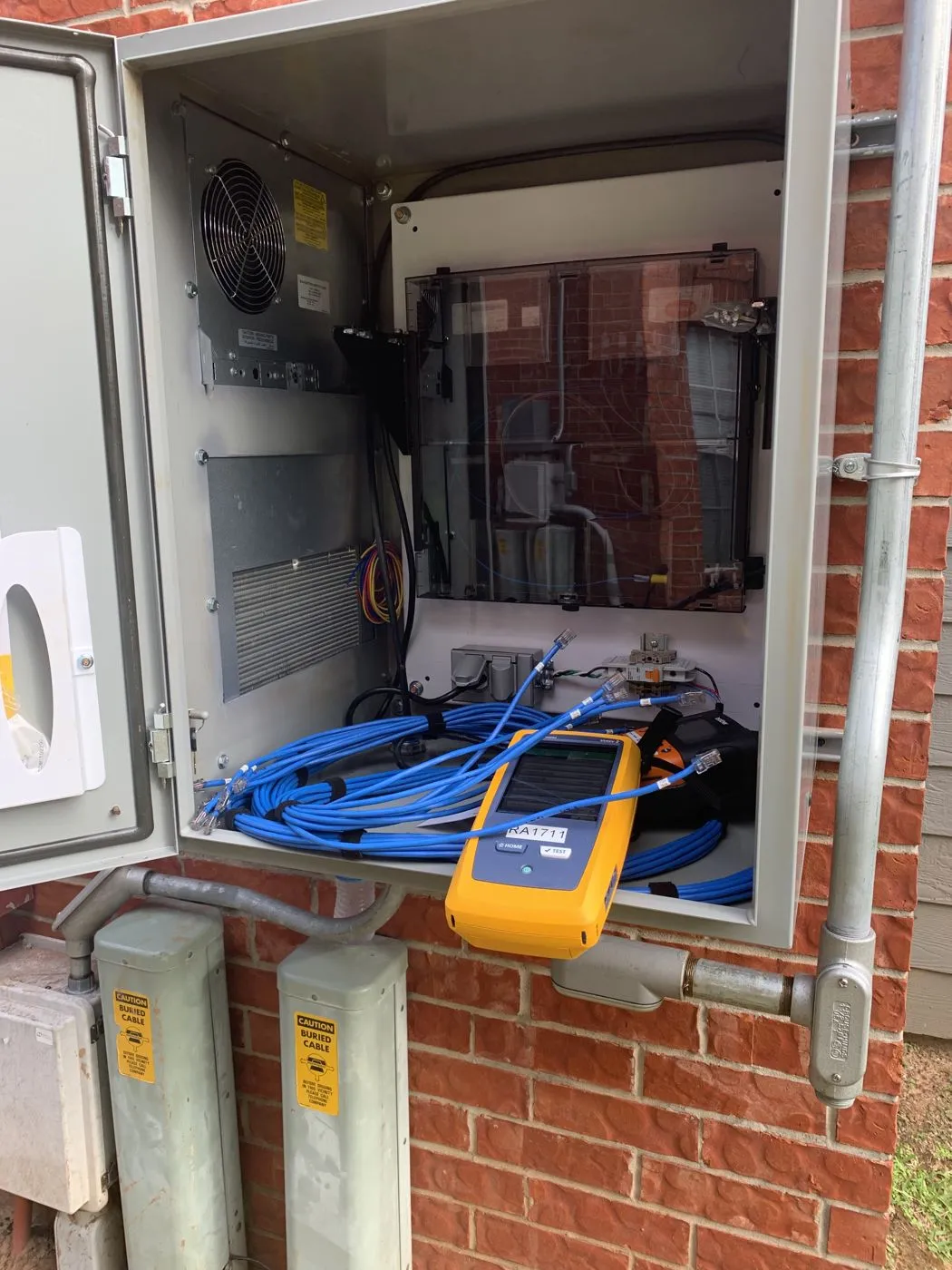 Outdoor network enclosure with a Fluke cable certification tester