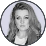 Black and white portrait of a woman with long hair and a serious expression, wearing a light top and a dark jacket.