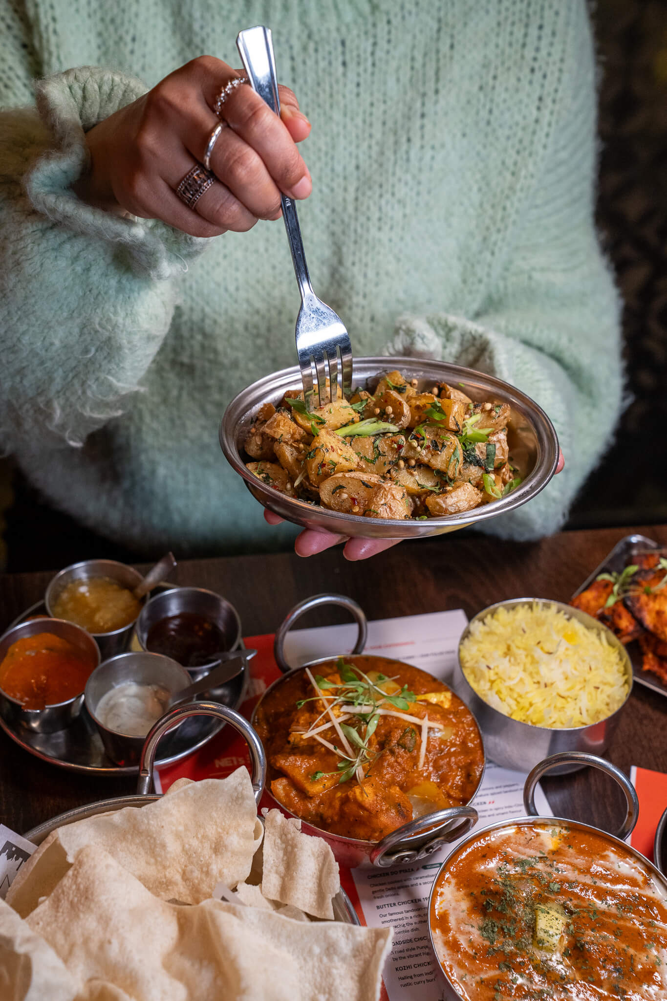 A Restaurant Week spread at My Delhi featuring Gunpowder Potatoes, street plates and classic Delhi roadside curries served for sharing.