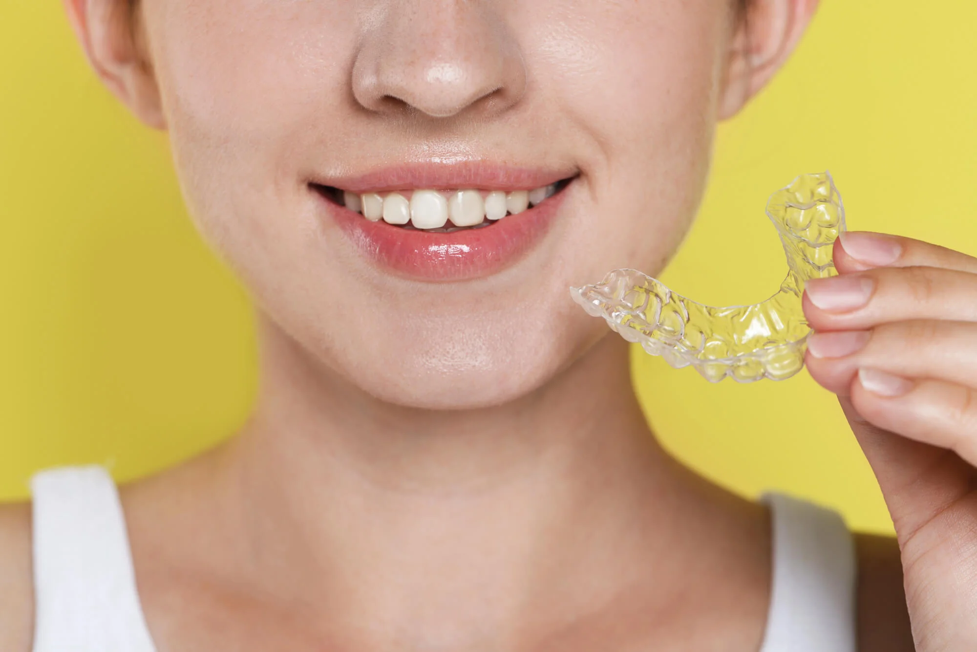 A patient holding Invisalign in Vienna, VA.