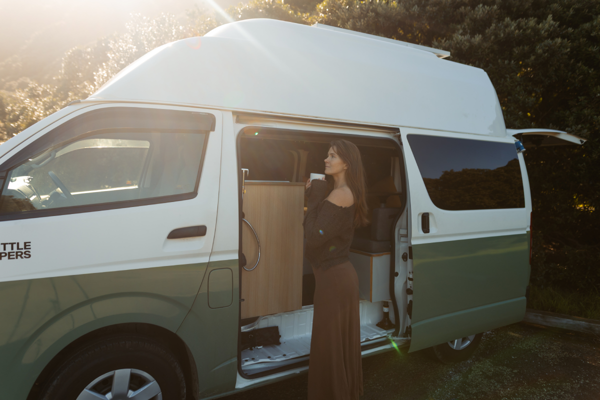 Side view of The Big One, a Big Little Campers high-top campervan, with the sliding door open
