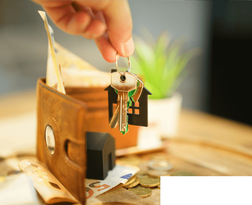 A hand holding a key next to a house key inside an open wallet.