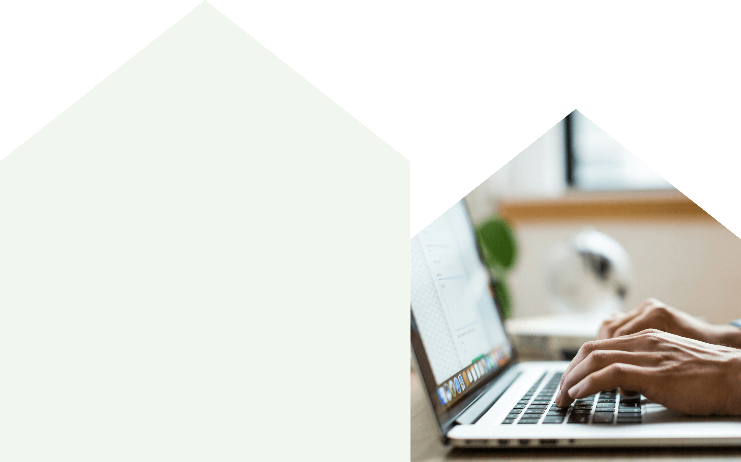 A person focused on typing on a laptop computer, with hands positioned on the keyboard.

