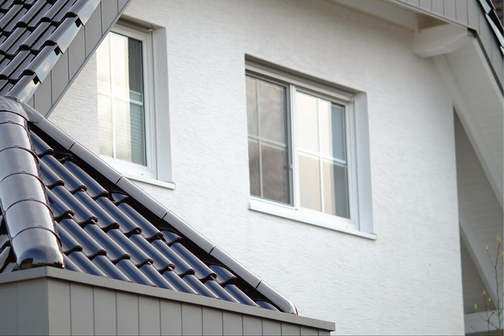 A house featuring a roof equipped with solar panels, showcasing a commitment to renewable energy.

