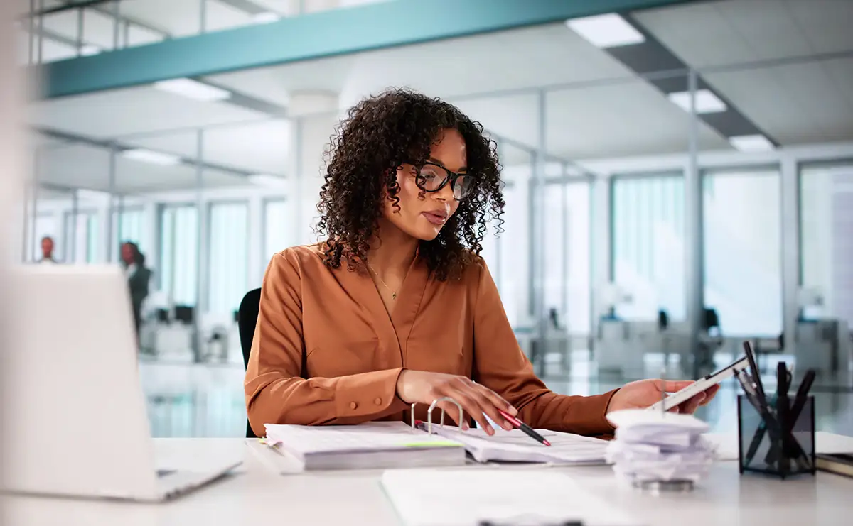 Woman doing bookkeeping or accounting at financial institution
