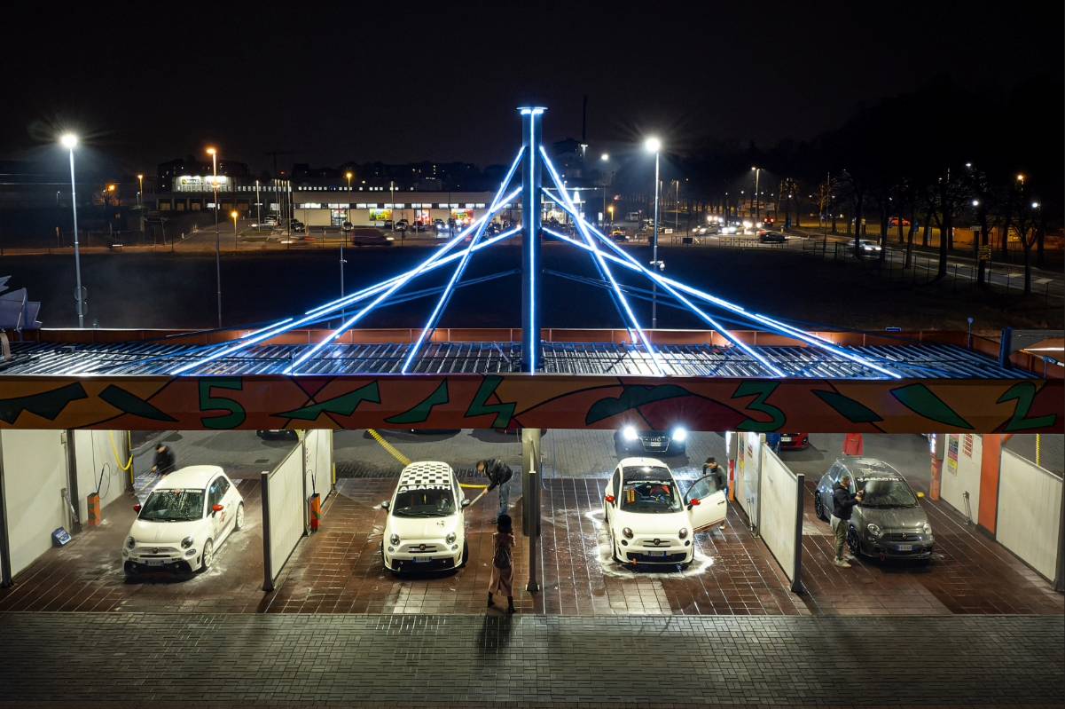 Man using self car wash at night