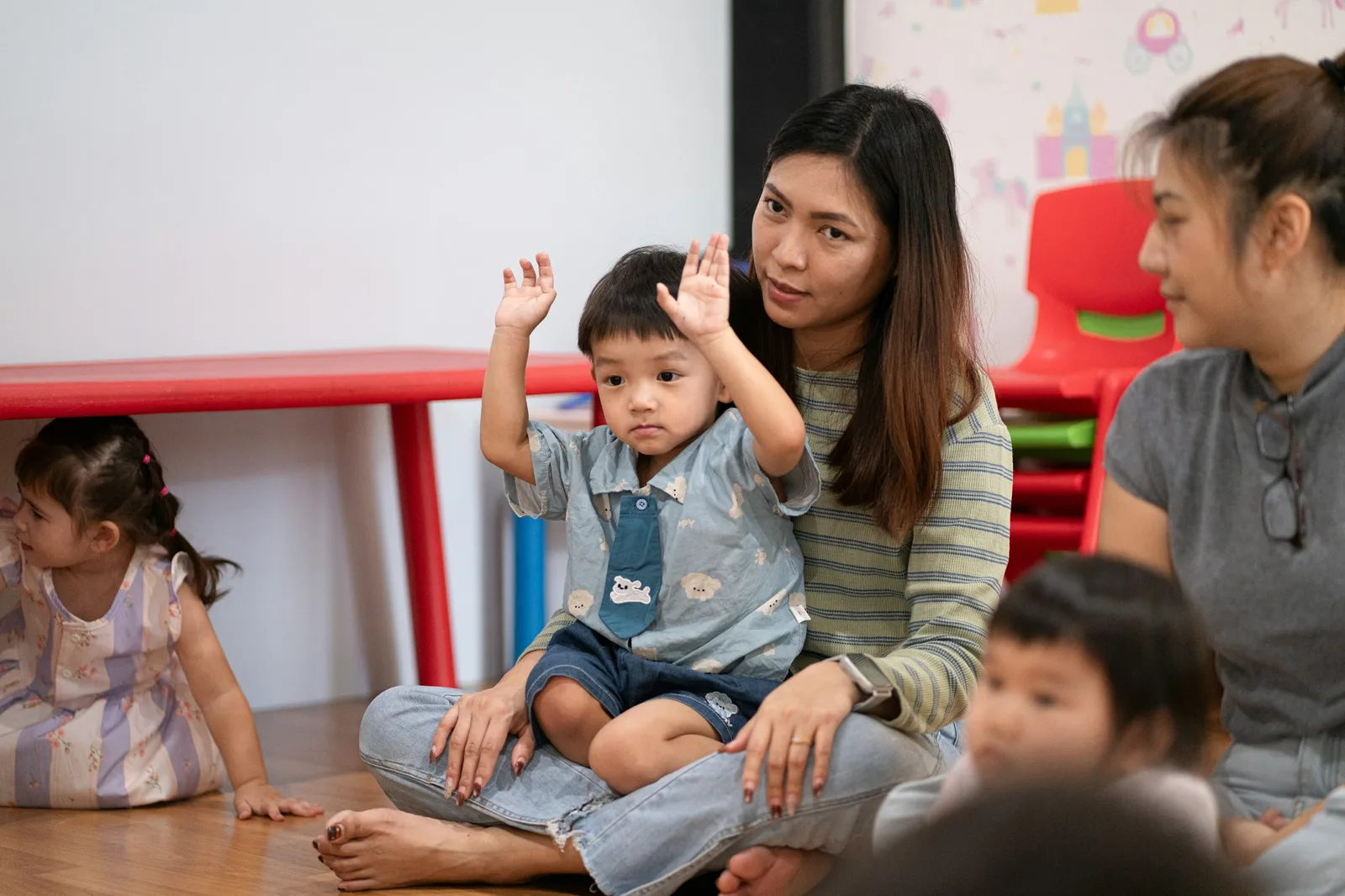 Representative scene of an adult leading a play-based activity with young children.