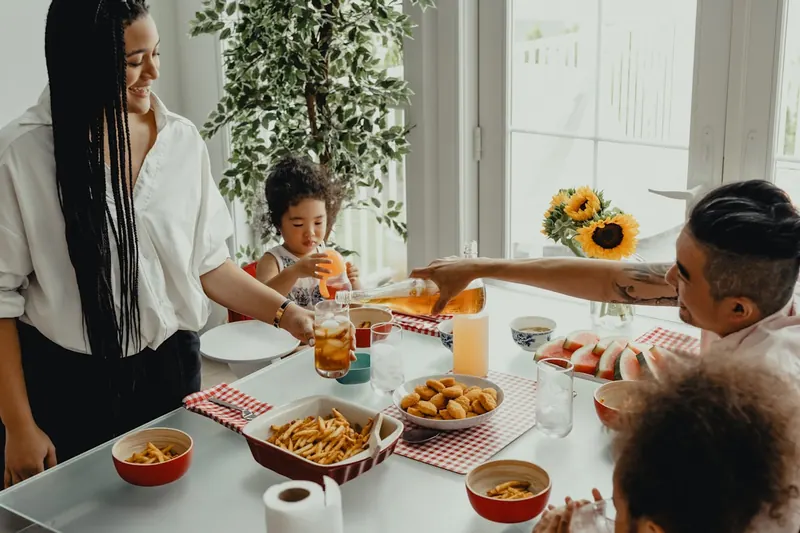 A family sharing a meal together at the dining table.