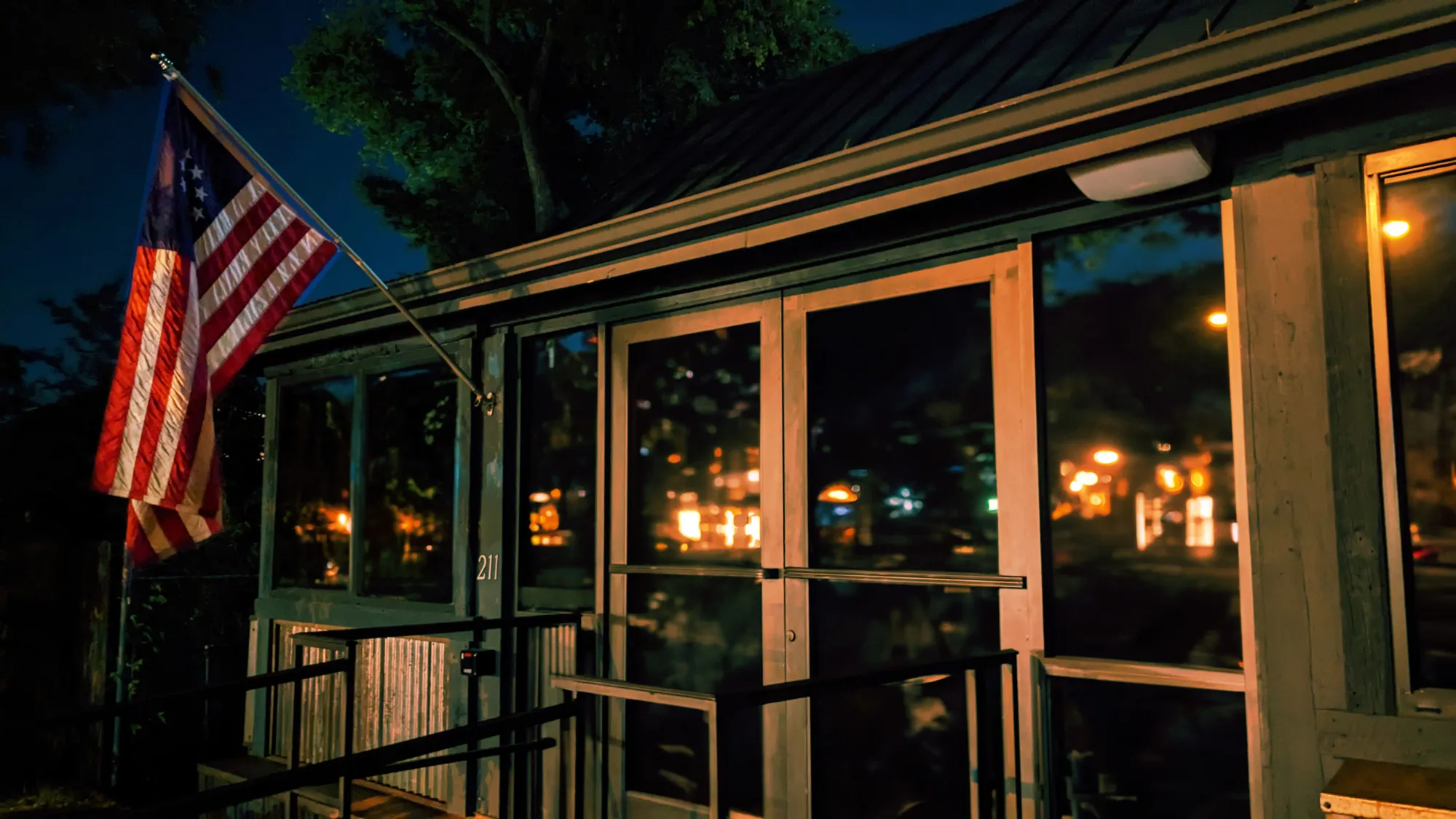 The Betsy entrance at night with The Betsy flag shining bright infront. 
