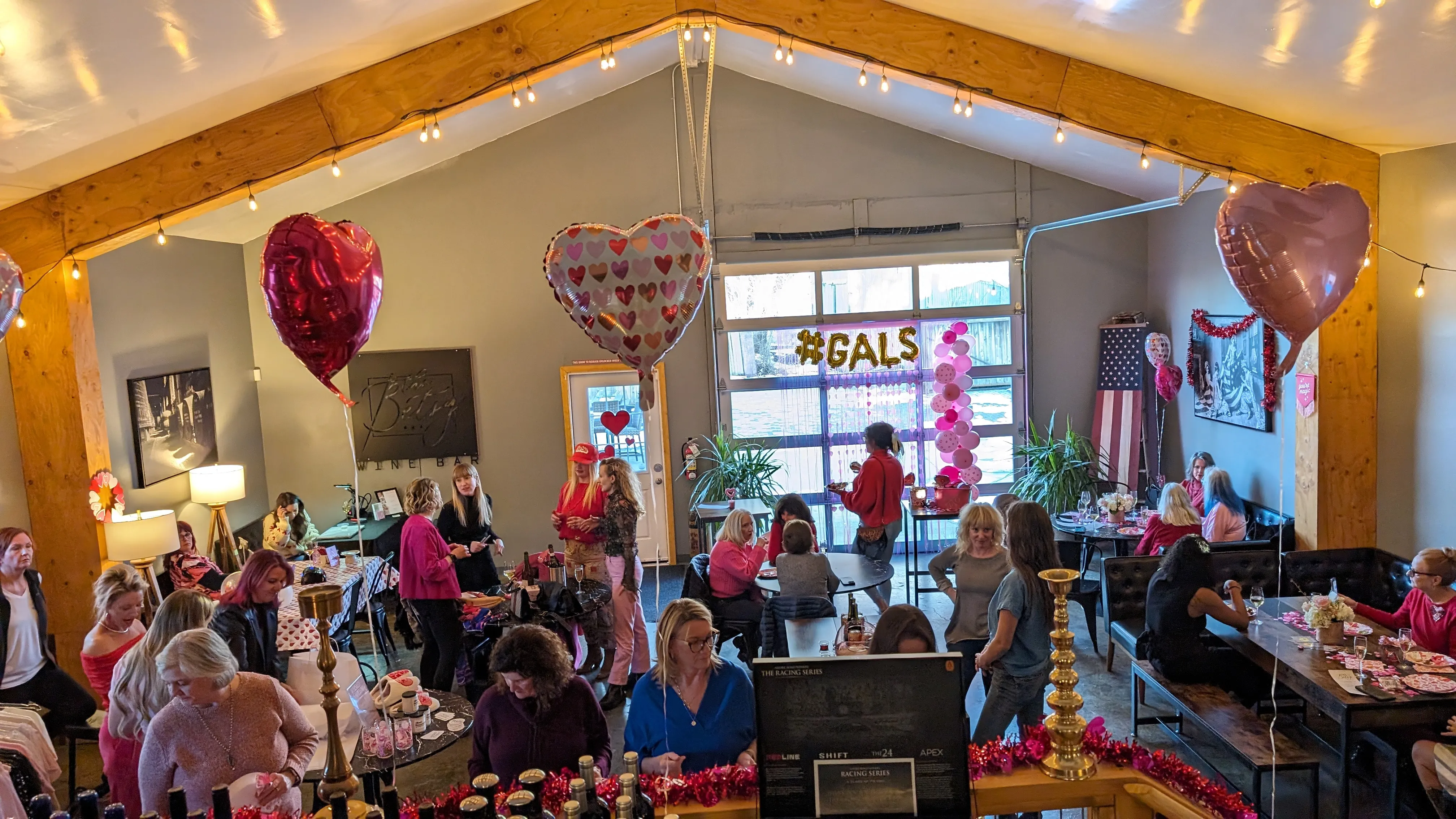 Special Galentine's Day event in The Founders Room for members of The Betsy. Lots of valentine's day decor, wine and food all around as people celebrate. 