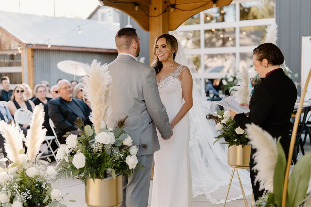A bride and groom exchanging vows on The Starlight Patio at The Betsy