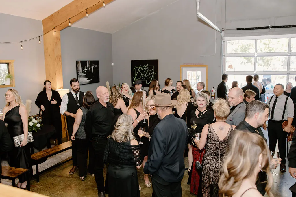Wedding guests mingling at a reception inside The Betsy