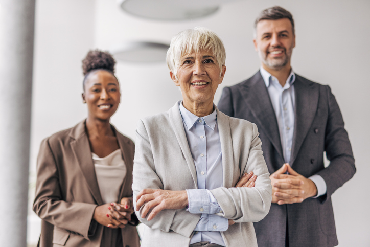Gender diverse corporate team standing confidently